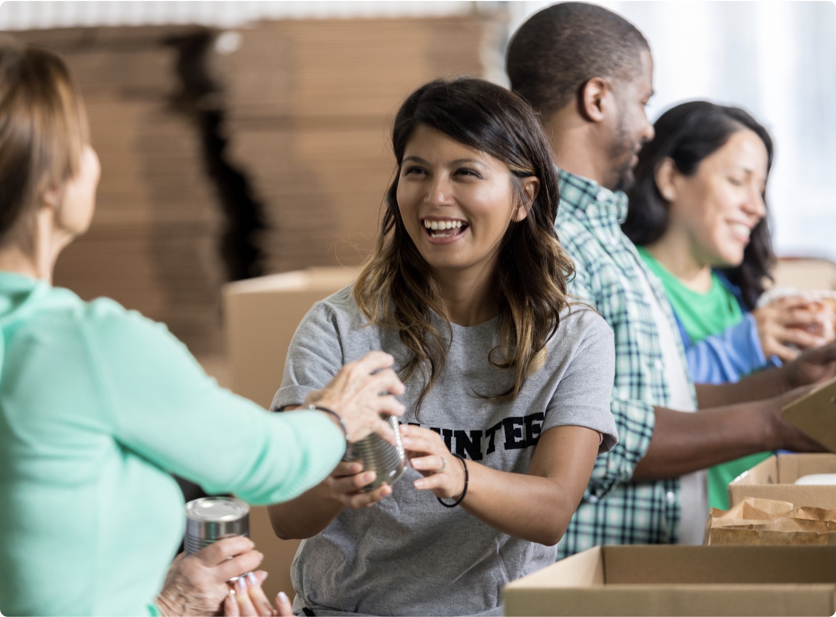 Volunteers working together with canned food